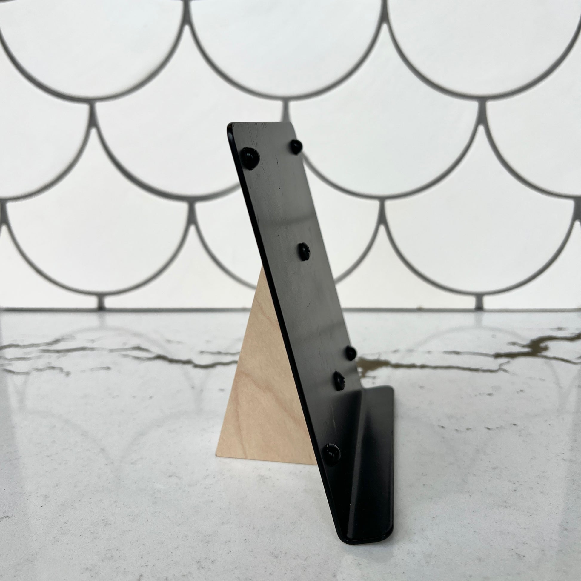 Mosaic Stand - wood base and metal back  in front of White Fish Scale tiles